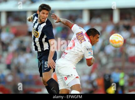 Buenos Aires, Argentina. 10th Feb, 2015. Huracan's Ramon Abila (R) of Argentina vies with Alianza Lima's Marcos Miers (L) of Peru during the match of Copa Libertadores in Buenos Aires, Argentina, on Feb. 10, 2015. Credit:  Juan Roleri/TELAM/Xinhua/Alamy Live News Stock Photo