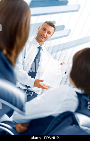 Portrait of young business people  discussing project in office environment Stock Photo
