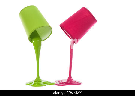 pouring paint from colored container on white background Stock Photo