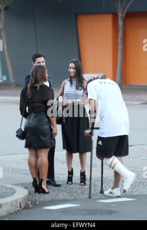 Sydney, Australia. 11 February 2015. Local celebrities attended the Fifty Shades of Grey launch party and exclusive first screening at Moore Park, Sydney. Pictured are TV personality Scott Tweedie and girlfriend model Georgia Berg talking with Krit Schmidt as they arrive. Credit: Richard Milnes/Alamy Live News Stock Photo