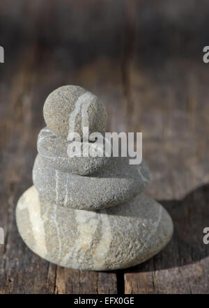 Stones pyramid on wooden symbolizing zen, harmony, balance Stock Photo
