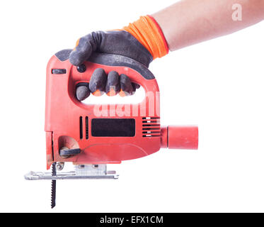 man's hand in a glove holds a working electric jig saw isolated on white background Stock Photo