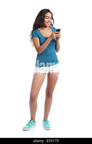 Full body of a teenager girl texting in a smart phone isolated on a white background Stock Photo