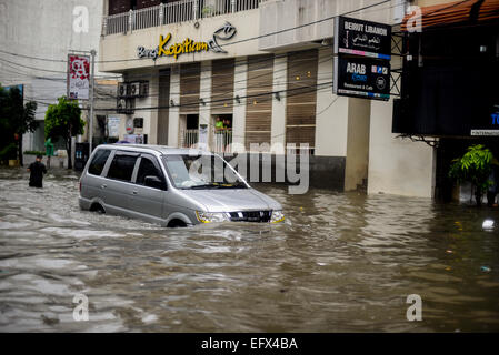 A car moving through floodwater, after a continuous rain left the downtown area of Jakarta flooded. Stock Photo