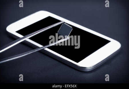 tweezers with parts for electronics repair Stock Photo