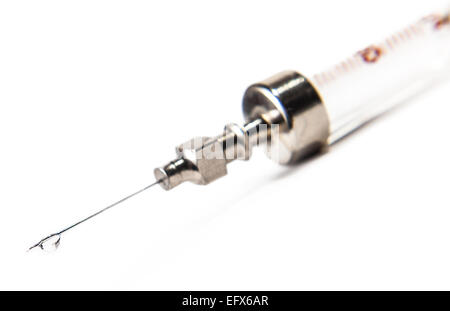 drop on syringe needle on white background Stock Photo