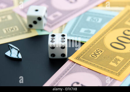 February 8, 2015: Houston, TX, USA.  Monopoly iron, dice and money Stock Photo