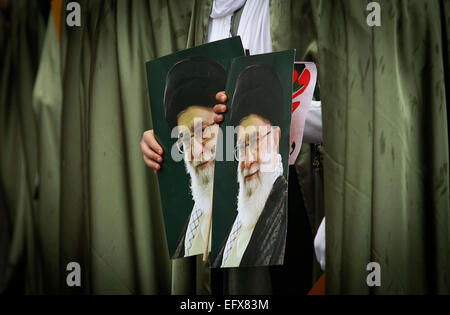 (150211) -- TEHRAN, Feb. 11, 2015 (Xinhua) -- Iranian women hold posters of Iran's Supreme Leader Ayatollah Ali Khamenei during a rally to mark the 36th anniversary of the Islamic revolution at Azadi (liberty) Square in Tehran, Iran, on Feb. 11, 2015. The West should lift 'inhumane and illegal sanctions' against Iran as they try to reach a comprehensive nuclear deal with Tehran, Rouhani said on Wednesday as the country celebrated the 36th anniversary of the Islamic revolution. (Xinhua/Ahmad Halabisaz) Stock Photo
