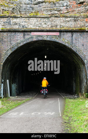 Cyclist entering Headstone Tunnel on the Monsal Trail in the Peak District Stock Photo