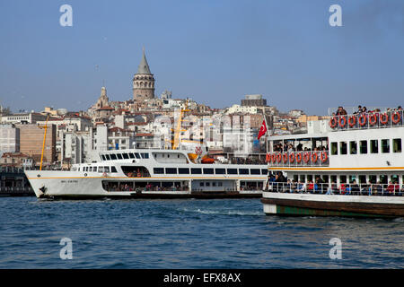 View across Bosphorus toward Galata Tower and Beyoglu, with 2 ferries in foreground, Istanbul, Turkey Stock Photo