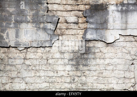 crumbling plaster texture with bricks Stock Photo