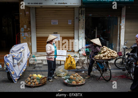 Women selling fruits and vegetables in the old quarter, Hanoi, Vietnam.