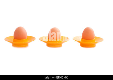 Tree eggs with yellow cups isolated over white Stock Photo