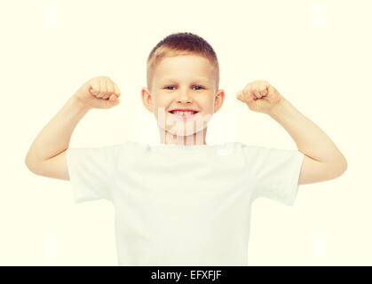 little boy in blank white t-shirt showing muscles Stock Photo