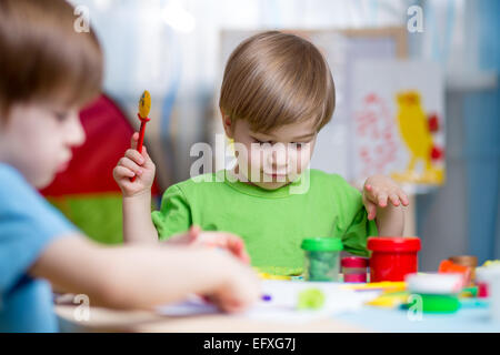 kids with play clay at home Stock Photo