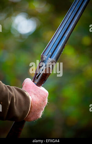 Man holding double-barrelled shotgun, close up Stock Photo