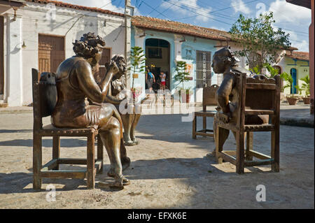 Horizontal close up of lifelike comical bronze statues in Camaguey, Cuba. Stock Photo