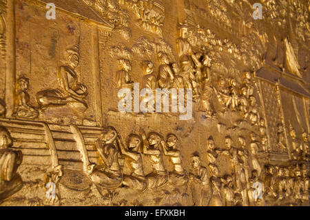 Horizontal close up of the large gold relief at Wat Mai Suwannaphumaham or New Monastery in Luang Prabang. Stock Photo