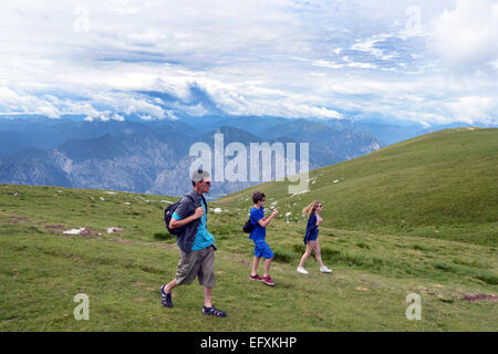 Teenagers on holiday in the Italian Lakes walking with their father. MODEL RELEASED Stock Photo