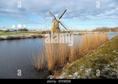 Drainage mill ''Hope springs eternal'' in typically Dutch flat landscape in winter, Voorhout, South Holland, The Netherlands. Stock Photo
