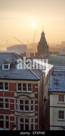 The sun rises behind the market tower of Newport City, the Millennium bridge and the New City Bridge can be seen. Stock Photo