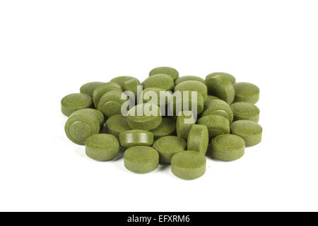A pile of Chlorella pills. Isolated on white. Chlorella is a genus of single-celled green algae and is a complete protein. It is Stock Photo