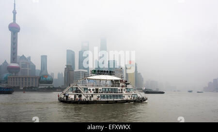 Huangpu River and tour boat with Pudong skyline in the fog, Shanghai, China Stock Photo