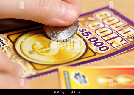 Coquitlam BC Canada - June 15, 2014 : Woman scratching lottery tickets. The British Columbia Lottery Corporation has provided go Stock Photo