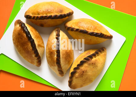 Traditional Bolivian savory pastries called Saltena filled with a kind of thick stew with meat Stock Photo