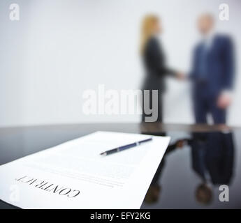 Business contract on background of handshaking partners Stock Photo