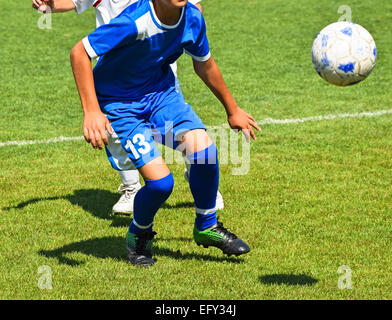 Kid soccer players in action Stock Photo