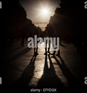 People walking down the high street in the late afternoon Stock Photo