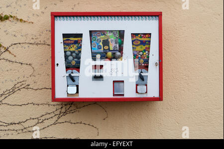Old chewing gum vending machine on a house wall, Austria Stock Photo