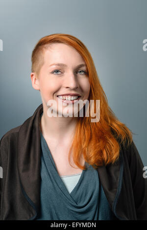 Close up Portrait of Smiling red haired Woman Looking at the Camera Stock Photo