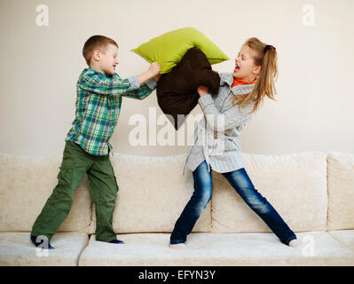 boy fights with girl pillow Stock Photo
