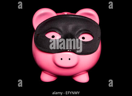 piggy bank wearing black masquerade mask cutout Stock Photo