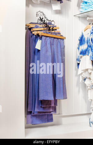 Blue trousers and jeans hanging in the shop Stock Photo