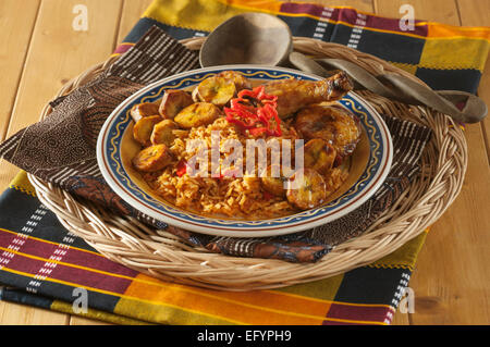Jollof rice with fried chicken and plantain. Stock Photo