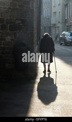 senior lady walking down street in villedieu les poeles, normandy, france Stock Photo