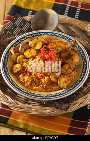 Jollof rice with fried chicken and plantain. Stock Photo
