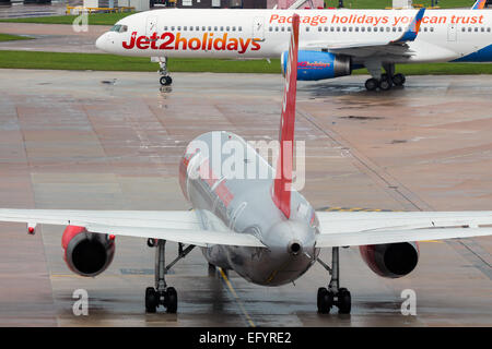 Jet2 Boeing 757-200 prepares for taxi to runway 23L, as a company aircraft takes the lead. Stock Photo