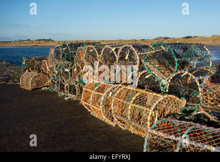 Lobster pots on the harbour wall, Beadnell, Norhumberland Stock Photo