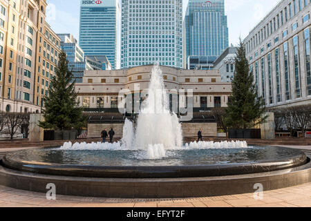 The skyscrapers of Canary Wharf seen behind the fountain in Cabot Square; towers include One Canada Square, HSBC and Citigroup Stock Photo