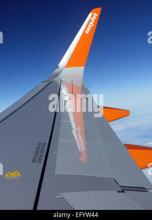 EasyJet logo on wingtip of Airbus A320 aircraft in flight Stock Photo