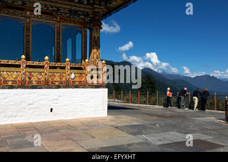 BU00102-00...BHUTAN - Tourist taking in the view of the Bhutanese Himalayas from the balcony of the Druk Wangyal Lhakhang. Stock Photo