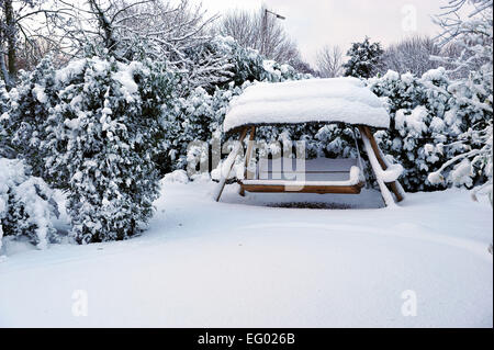 snow covered garden furniture England Stock Photo