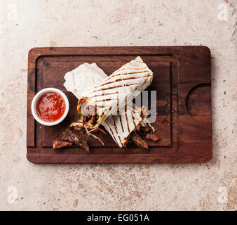 Doner Kebab grilled meat and vegetables on stone textured background Stock Photo