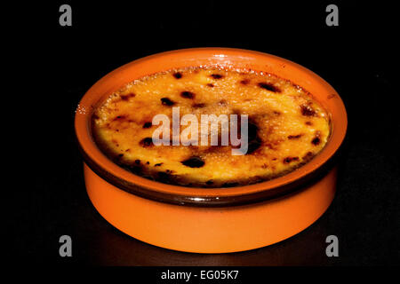 Creme Brulee (Crema Catalana) in a terracotta dish - studio shot Stock Photo