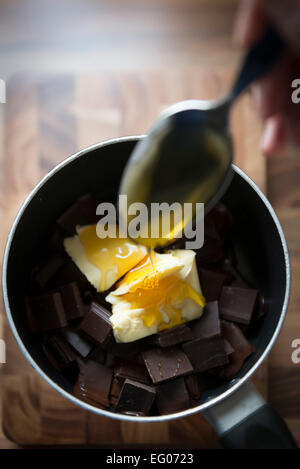 Baking with melted chocolate sauce in a saucepan. Stock Photo