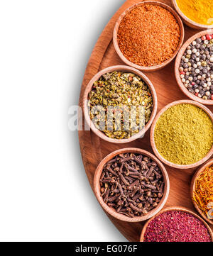 assorted spices in a wooden bowl on white background Stock Photo